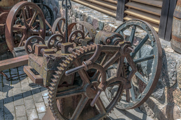 Old, rusty agricultural machinery of the last century, standing near the hangar.