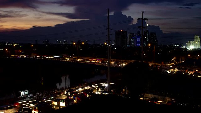 Time lapse of the busy highway and bridge under the beautiful red orange sunset.