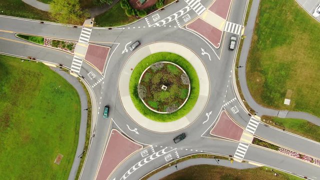 Aerial top down drone view of traffic circle roundabout, slowly descending
