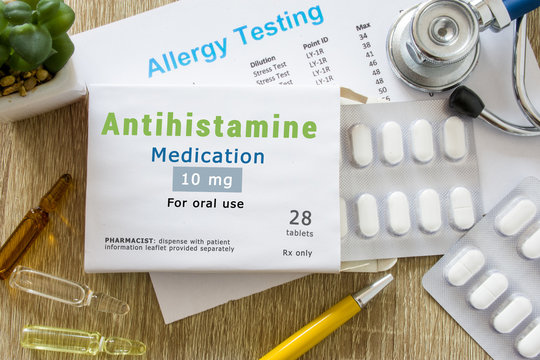 Antihistamine medication or allergy drug concept photo. On doctor table is pack with word "Antihistamine medication" and pills for treatment of allergy and hypersensitivity