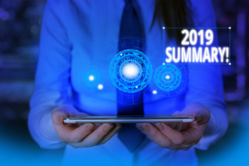 Conceptual hand writing showing 2019 Summary. Concept meaning summarizing past year events main actions or good shows Woman wear work suit presenting presentation smart device