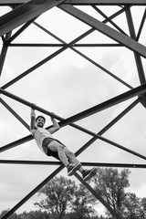 A young man with a beard of Caucasian appearance is engaged in sports in nature. Workout, lifestyle, healthy lifestyle, open air, day, black and white