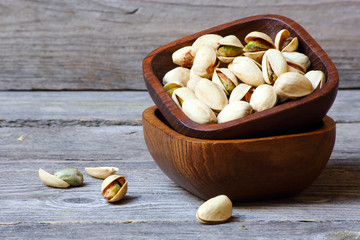 Pistachio nuts on a gray wooden table