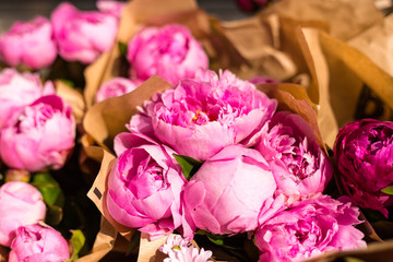 Freshly picked bouquet of peony flowers on display at the farmers market. Pink peonies for sale in floral shop © mdyn