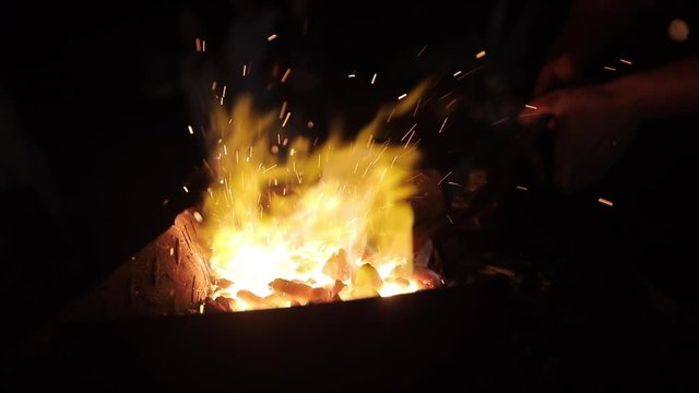 Professional blacksmith is keeping in the heat the metal workpiece