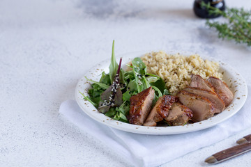 healthy lunch. Serving Couscous with Salad and Roasted Duck Breasts