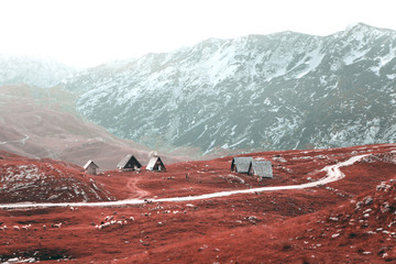View of the autumn landscape and tiny authentic houses in the highlands.