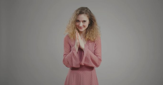 attractive young woman rubs palms in anticipation