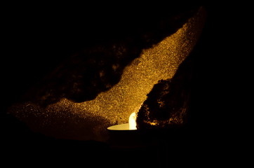 Fototapeta premium burning candle on black background