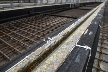 Fototapeta premium Repair of the railway tram line. Installation of new modern silent railway rails for trams. Laying of stone paving, road paving slabs on street. Repair of reconstruction of city roads with a tram line