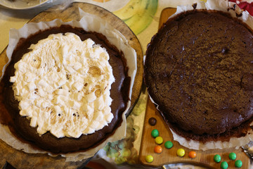 chokolate dough for cake in cooking process with murshmellow filling and colored sweets