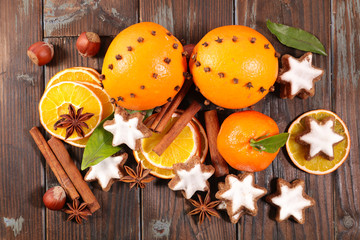 assortment of winter spices with gingerbread cookie, orange and clove, spices and nuts