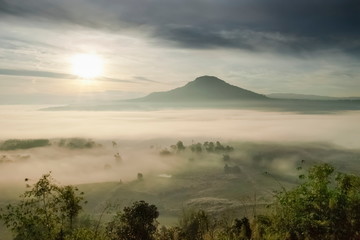 Obraz premium Mountain view misty morning of Peak mountain around with sea of mist with cloudy sky background, sunrise at Khao Takhian (Takian) Ngo, Khao Kho, Phetchabun, Thailand.