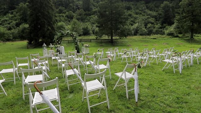 Wedding ceremony. White chairs on the grass