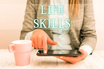 Fototapeta na wymiar Handwriting text writing Life Skills. Conceptual photo skill that is necessary for full participation in everyday life Business woman sitting with mobile phone and cup of coffee on the table