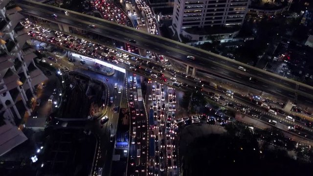 Jakarta, Indonesia rush hour night traffic. Aerial view of downtown Jakarta streets crowded with motorcycles, cars, and buses (Part 9)
