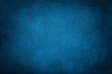 Dark blue matte background of suede fabric, closeup.