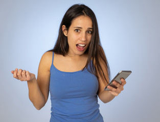 Attractive young woman looking at mobile smart phone shocked and surprised having lost of likes
