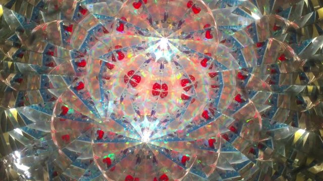 Abstract background (real shooting of kaleidoscope, no digital effect. Fast movement with little rays of light. Multicolor. 