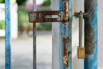 The old rusty fence gate and a padlock