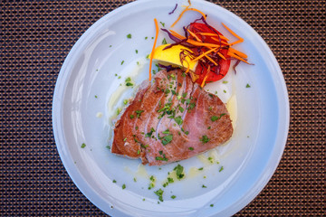 Grilled tuna steak with vegetables, mediterranean served fish dish