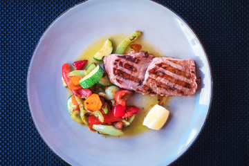 Grilled tuna steak with vegetables, mediterranean served fish dish