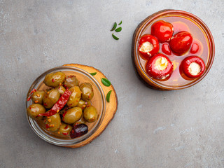 Italian food ingredients background with olives, oil red stuffes with cheese bell peppers
