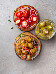 Italian food ingredients background with olives, oil red stuffes with cheese bell peppers