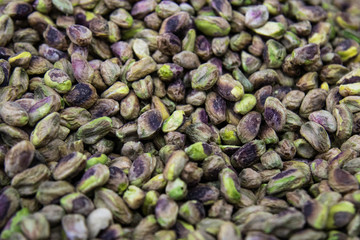 Nutty background of green and purple pistachio nuts