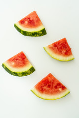 A pattern with watermelon slices on a white table.
