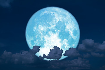 blue strawberry moon back on silhouette heap cloud on sunset sky