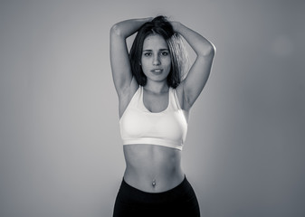 Portrait of sporty beautiful brunette woman in sport clothes looking sensual and fit