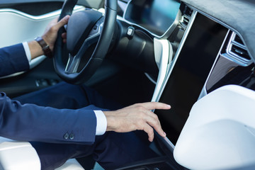 Close up of businessman using navigation system in his car