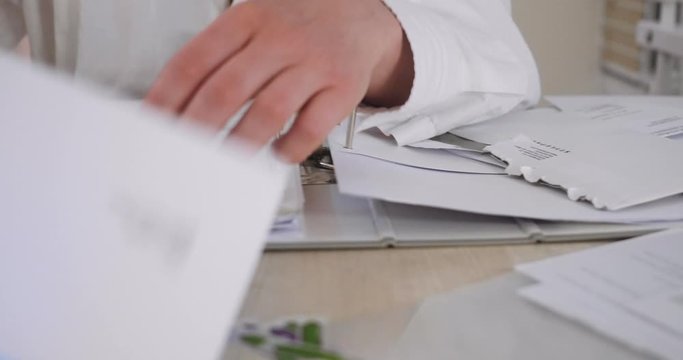 Lab Worker Hands and Papers on Desk