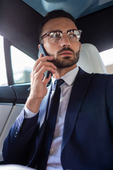 Stylish businessman wearing suit and tie calling his wife