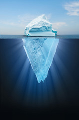Iceberg floating in the ocean, both the tip and the submerged parts are visible. Top part is smaller than bottom.