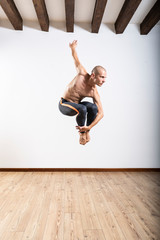 Beautiful male ballett dancer performing indoor