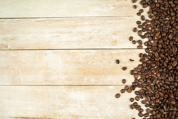 Coffee beans frame with beans at the right side on a oak background