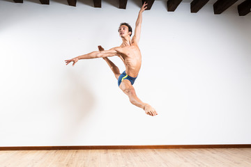 Beautiful male ballett dancer performing indoor