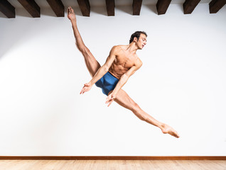 Beautiful male ballett dancer performing indoor