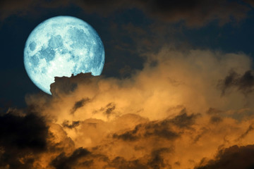 Obraz na płótnie Canvas super blue harvest moon back on silhouette cloud on sunset sky