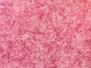 Texture of red wallpaper with a pattern. Decorative plaster backdrop.