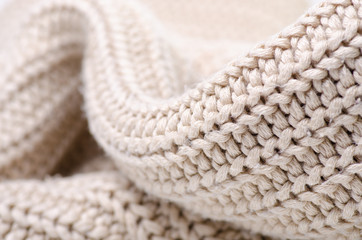 Fototapeta na wymiar Beige warm knited material fabric sweater texture blur background