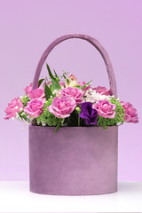 bouquet of pink roses in a box / basket lilac .