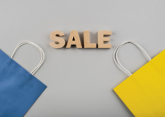 Top view of sale letters with yellow and blue bag