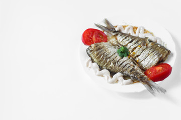 two raw fish on a white plate