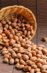 Hazelnut fruits. Healthy diet vegetarian food. Filbert natural healthy hazel sprinkled from a basket on a brown background. Crop Production, Nut Harvesting Season