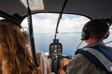View out the cockpit of a helicopter over the Whitsunday Islands on a fight to the Great Barrier...
