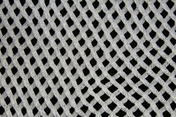 Foam netting sleeves (EPE fruit nets) on black background.