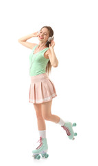 Beautiful young woman on roller skates listening to music against white background